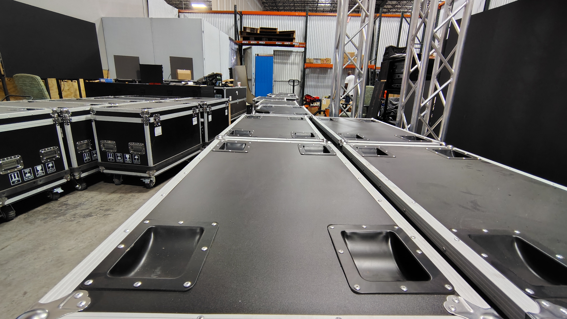 QSE owned-inventory flight cases staged in the Orlando warehouse, rental-ready
