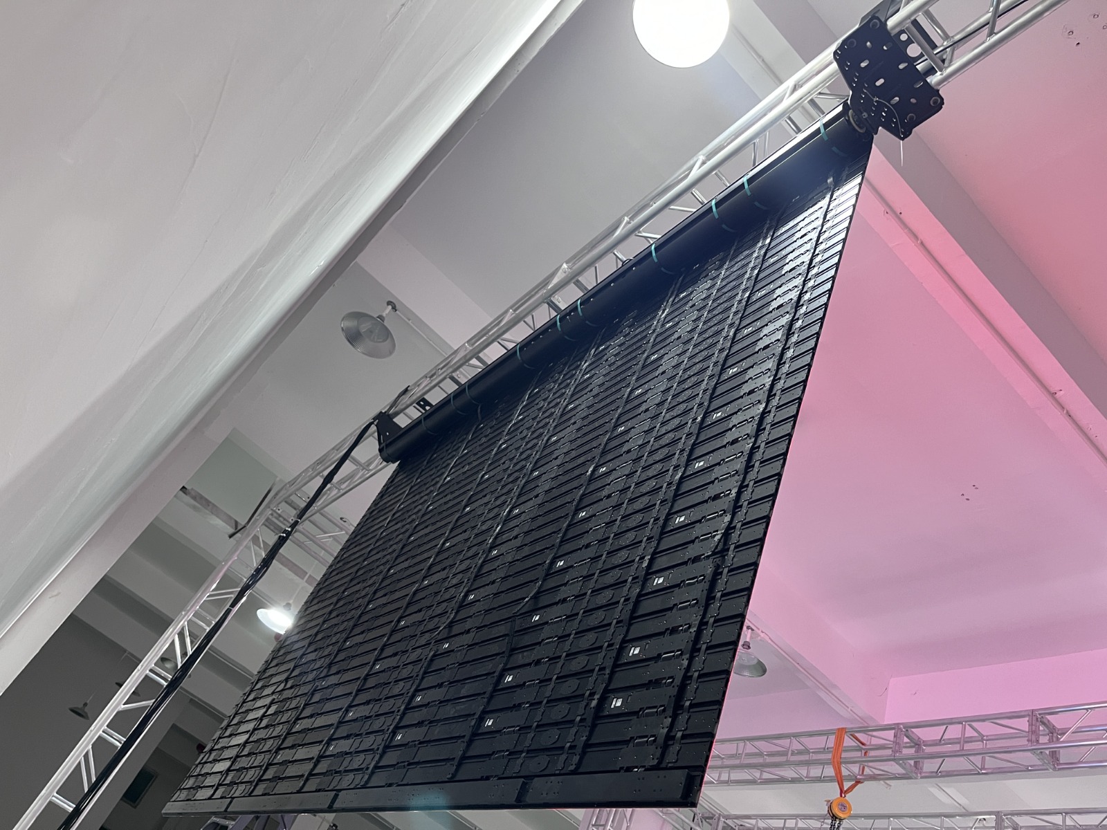 Back of rolling LED panels suspended from truss